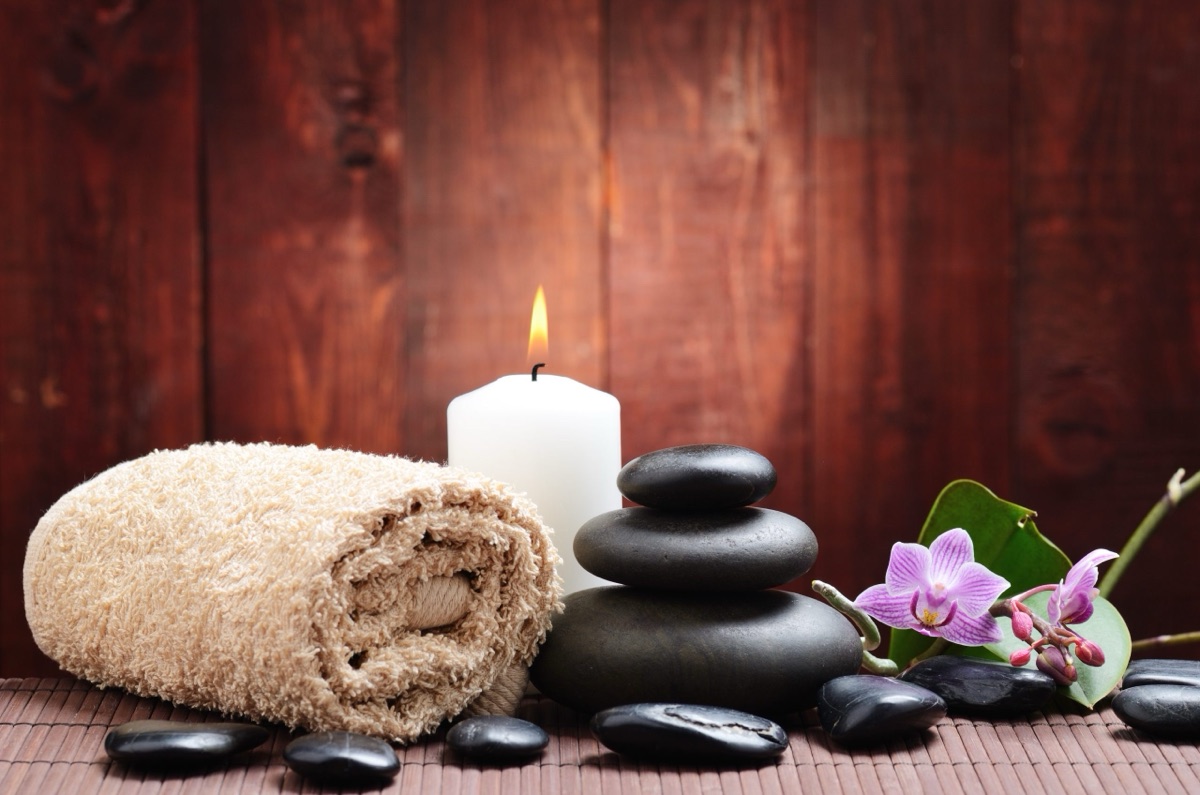 hot stones, towel and candle in the treatment room